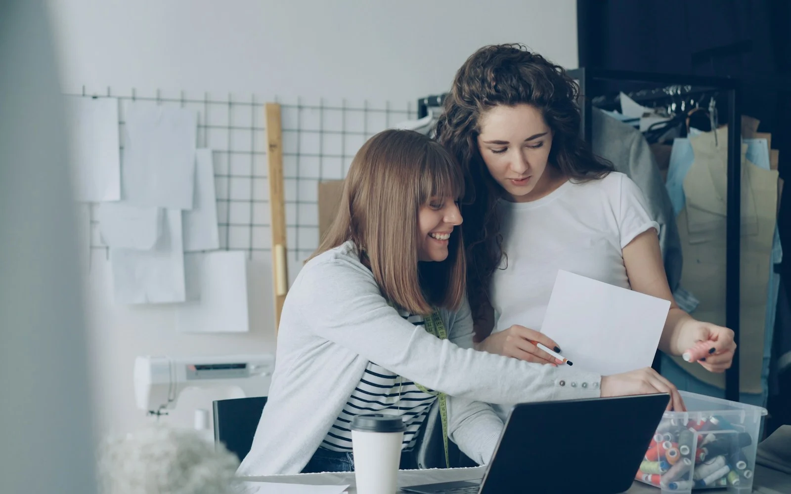 Duas mulheres revisando juntas uma folha de papel
